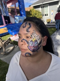 a woman with a face paint on her face